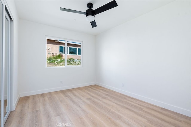 spare room with light wood-type flooring and ceiling fan