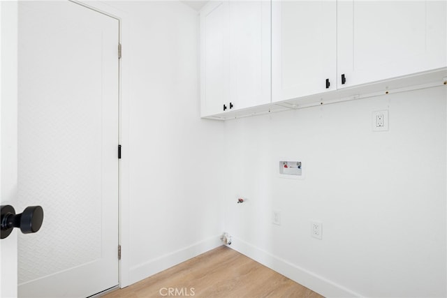 clothes washing area featuring washer hookup, cabinets, and light hardwood / wood-style floors