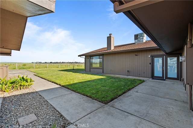 view of yard with french doors and a patio area