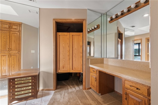 bathroom with tile floors and vanity