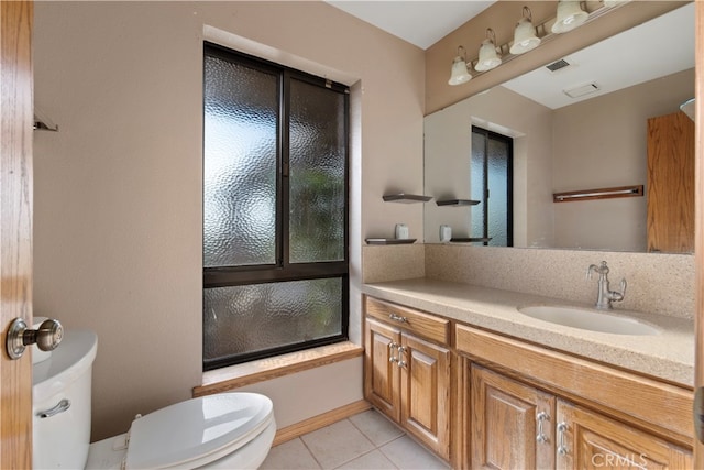 full bathroom with tile flooring, vanity, toilet, and bath / shower combo with glass door