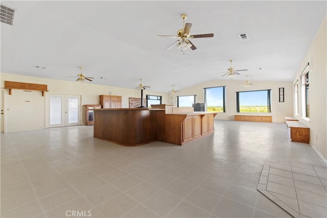 kitchen featuring french doors, lofted ceiling, light tile flooring, and ceiling fan