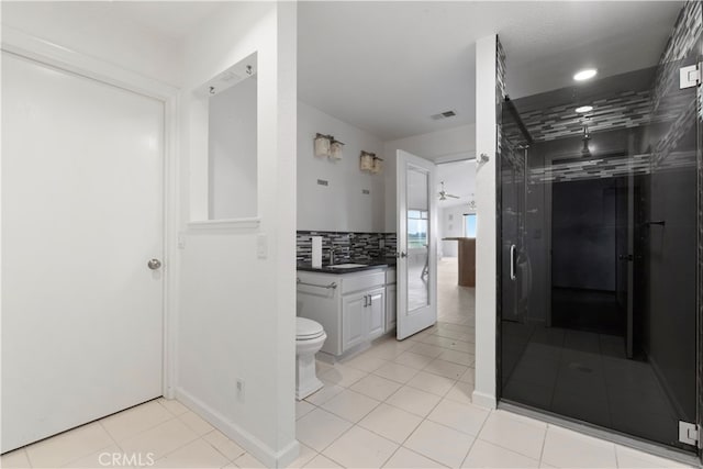 bathroom featuring ceiling fan, toilet, tasteful backsplash, tile flooring, and vanity