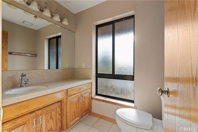 full bathroom with bath / shower combo with glass door, vanity, toilet, and tile floors