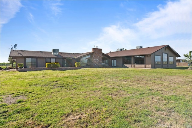 back of house featuring a yard