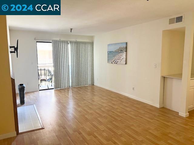 empty room with wood-type flooring