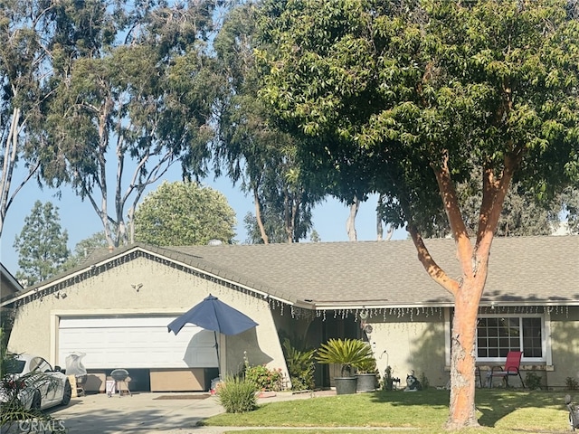 view of front of house with a front yard and a garage