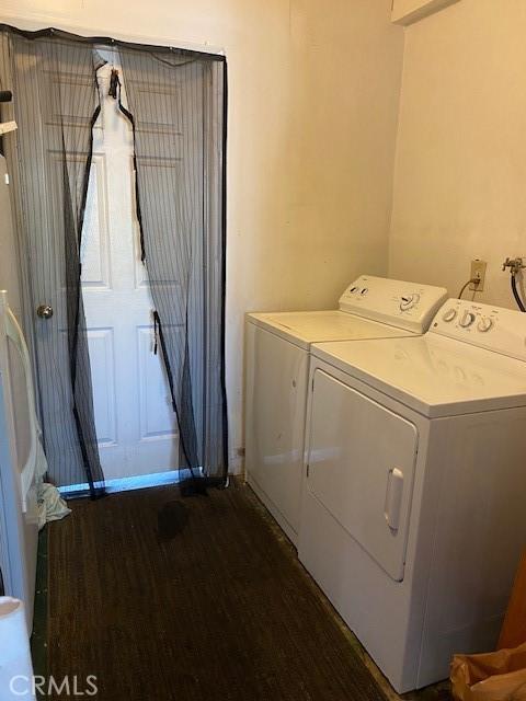 laundry area featuring washing machine and dryer and dark wood-type flooring