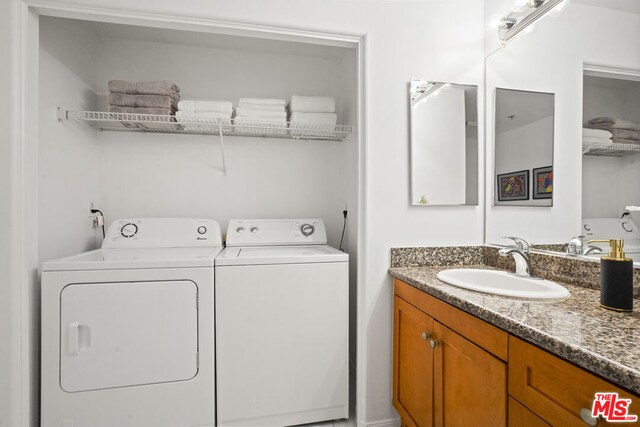 laundry area featuring washer and clothes dryer and sink