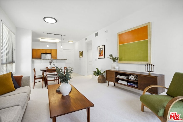 carpeted living room featuring rail lighting