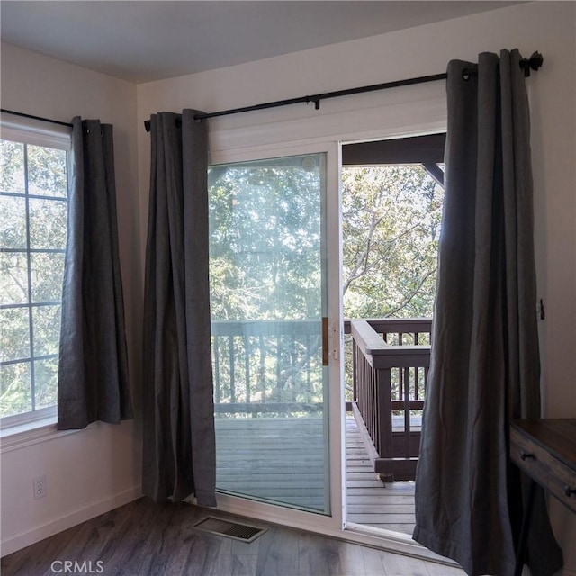 doorway to outside with a healthy amount of sunlight and hardwood / wood-style flooring