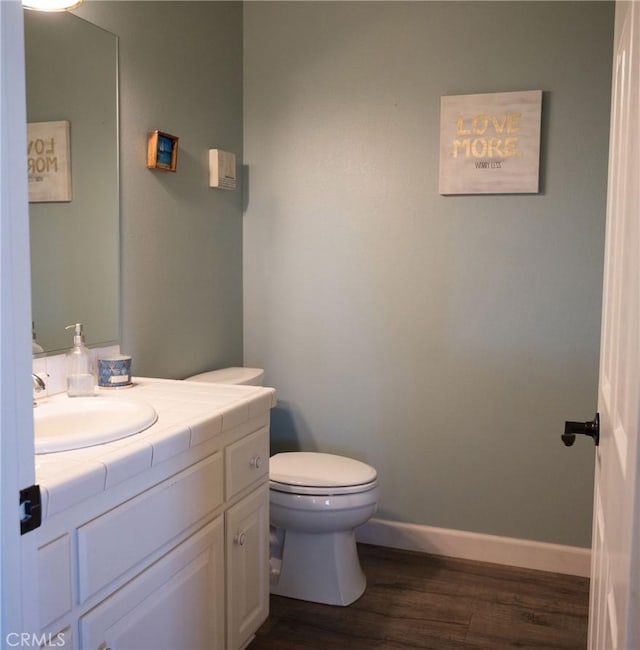 bathroom featuring hardwood / wood-style floors, vanity, and toilet