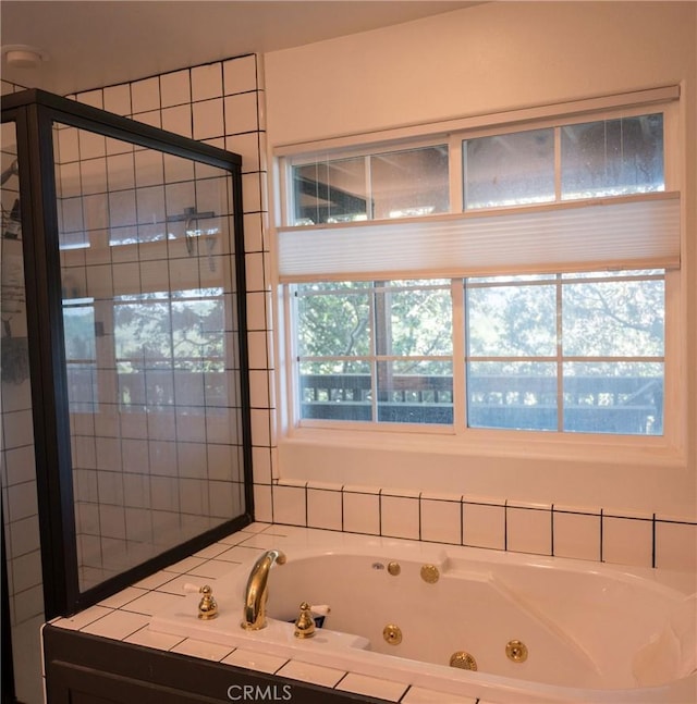 bathroom with a wealth of natural light and independent shower and bath