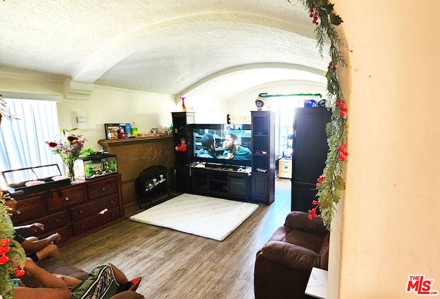 living room with wood-type flooring and a textured ceiling