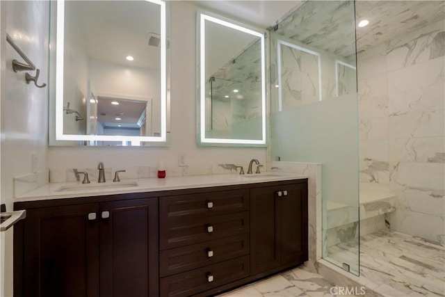 bathroom featuring a tile shower and vanity