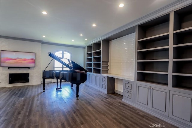 misc room with dark hardwood / wood-style floors, built in desk, and crown molding