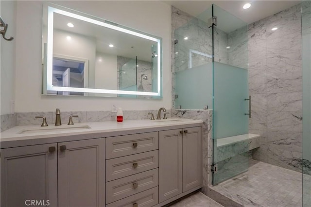 bathroom featuring vanity and an enclosed shower