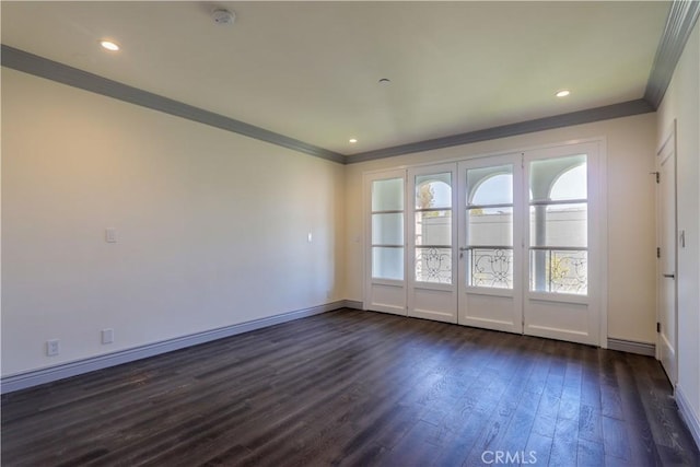 spare room with dark hardwood / wood-style flooring and ornamental molding