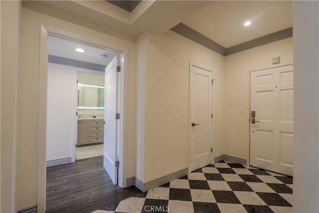 foyer featuring ornamental molding and dark wood-type flooring