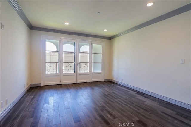 empty room with crown molding and dark wood-type flooring