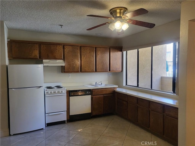 kitchen featuring ceiling fan, white appliances, a textured ceiling, and light tile patterned floors