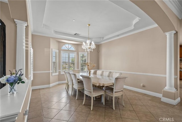 tiled dining space featuring a chandelier, a tray ceiling, and crown molding