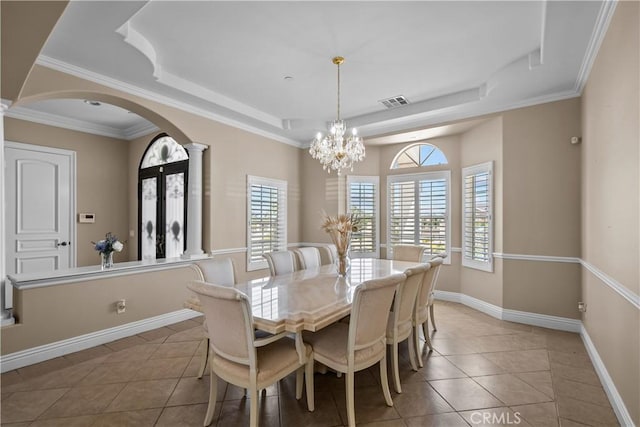 dining room featuring tile patterned floors, crown molding, and a notable chandelier