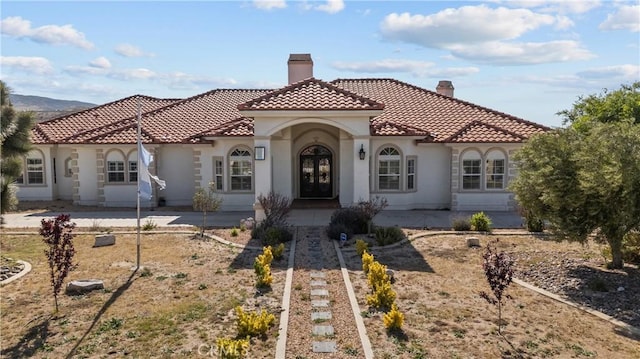 mediterranean / spanish house with a patio