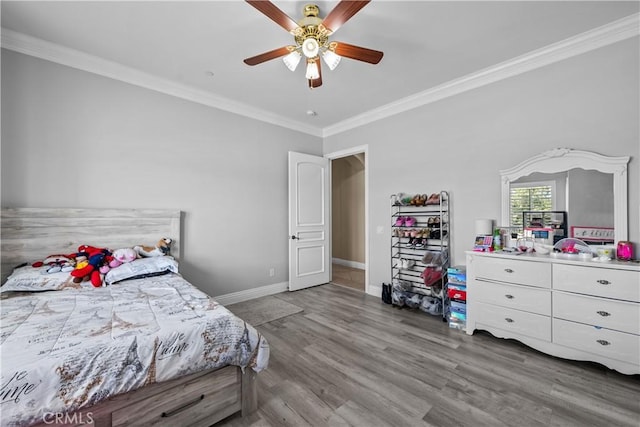 bedroom with hardwood / wood-style flooring, ceiling fan, and ornamental molding