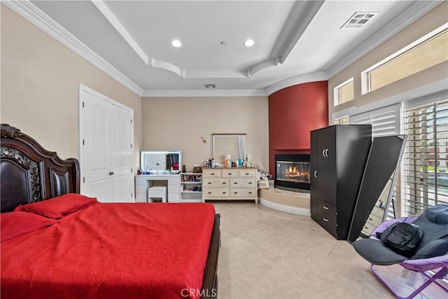 bedroom with a raised ceiling and ornamental molding