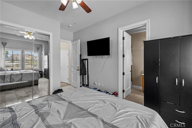 bedroom featuring ensuite bath and ceiling fan