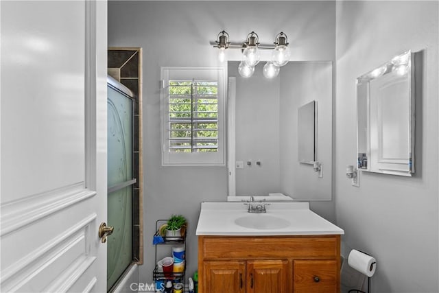 bathroom featuring vanity and shower / bath combination with glass door