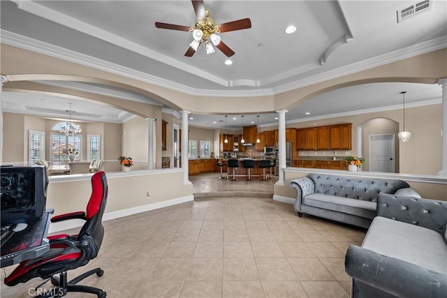 interior space with ceiling fan with notable chandelier, a raised ceiling, and ornamental molding