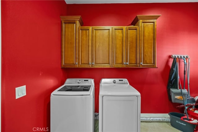 clothes washing area featuring cabinets, carpet floors, and separate washer and dryer