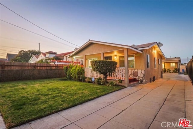 view of front of home with a lawn