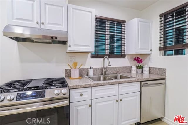 kitchen featuring white cabinetry, sink, and appliances with stainless steel finishes