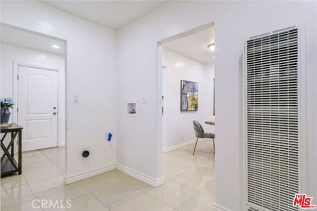 laundry area with light tile patterned floors and hookup for a washing machine