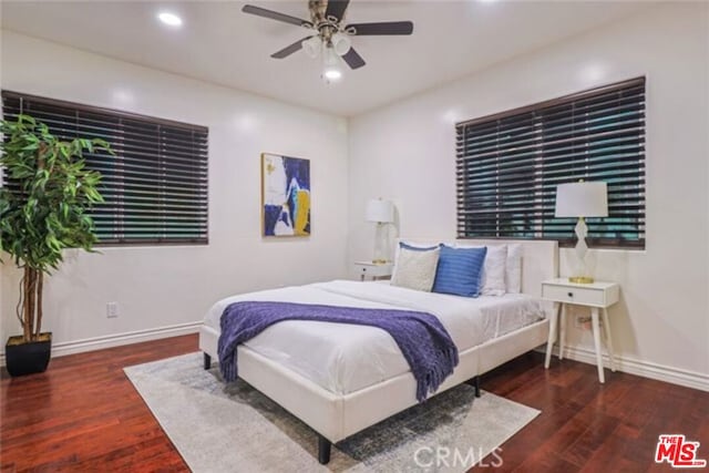 bedroom with ceiling fan and dark hardwood / wood-style flooring