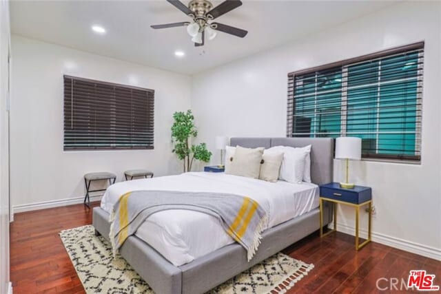 bedroom featuring ceiling fan and dark hardwood / wood-style floors