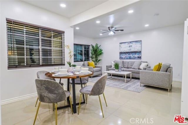 tiled dining room with ceiling fan