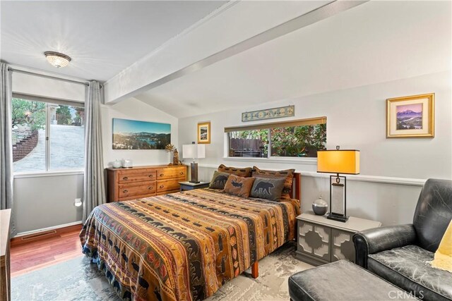 bedroom with light wood-type flooring, visible vents, lofted ceiling with beams, and baseboards