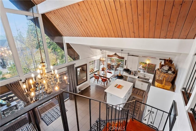 interior space featuring lofted ceiling with beams, wooden ceiling, and an inviting chandelier