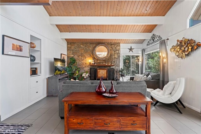 living room with vaulted ceiling with beams, built in shelves, and wooden ceiling