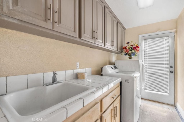 laundry room with cabinets and sink