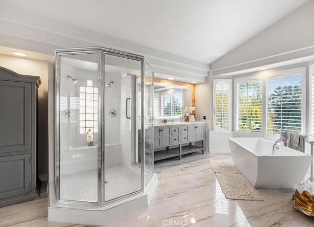 bathroom with vanity, vaulted ceiling, and shower with separate bathtub