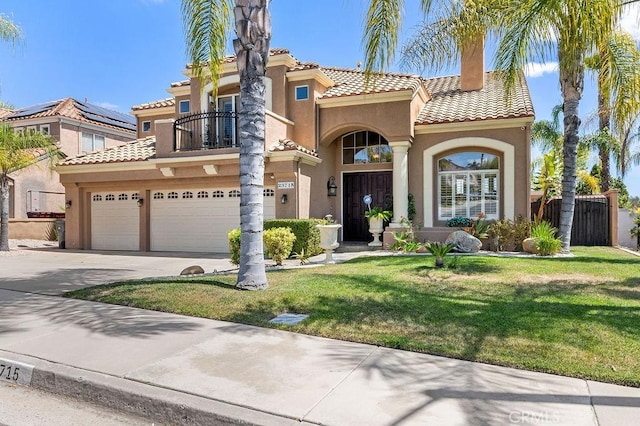 mediterranean / spanish-style house featuring a balcony, a garage, and a front lawn