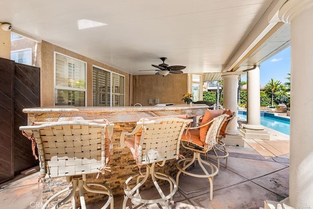 view of patio / terrace with ceiling fan and exterior bar