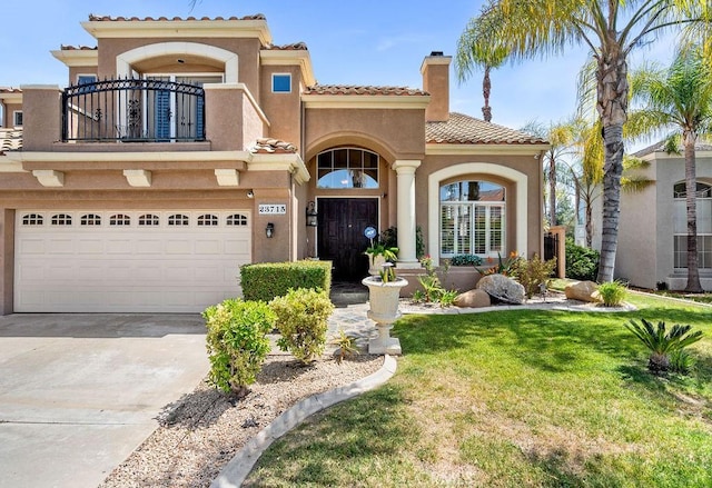 mediterranean / spanish home with a balcony, a garage, and a front lawn