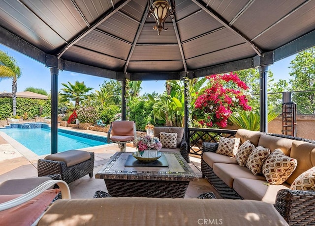 exterior space featuring a gazebo, an outdoor living space, and a patio