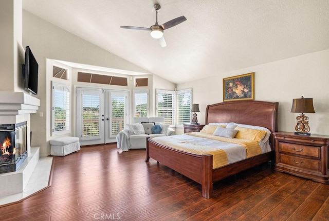 bedroom with lofted ceiling, dark wood-type flooring, access to outside, french doors, and ceiling fan